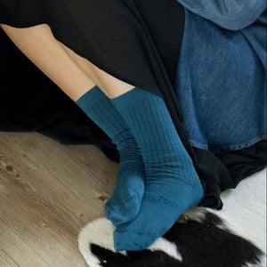 Woman wearing Lamington merino crew socks in deep teal rib knit made in New Zealand.