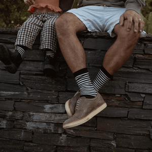 Man wearing Lamington merino crew socks in black with latte stripes made in New Zealand.
