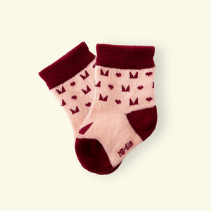 Mosey by Lamington merino baby socks in plum with geometric pattern.