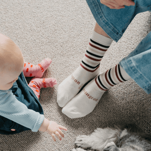 Woman wearing Lamington merino crew socks in cream with burgundy, black and latte stripes made in New Zealand.