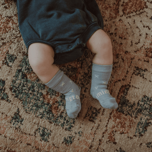 Merino Wool Crew Socks for Baby in Beau - Light Blue with Natural Cross pattern on a baby's feet.