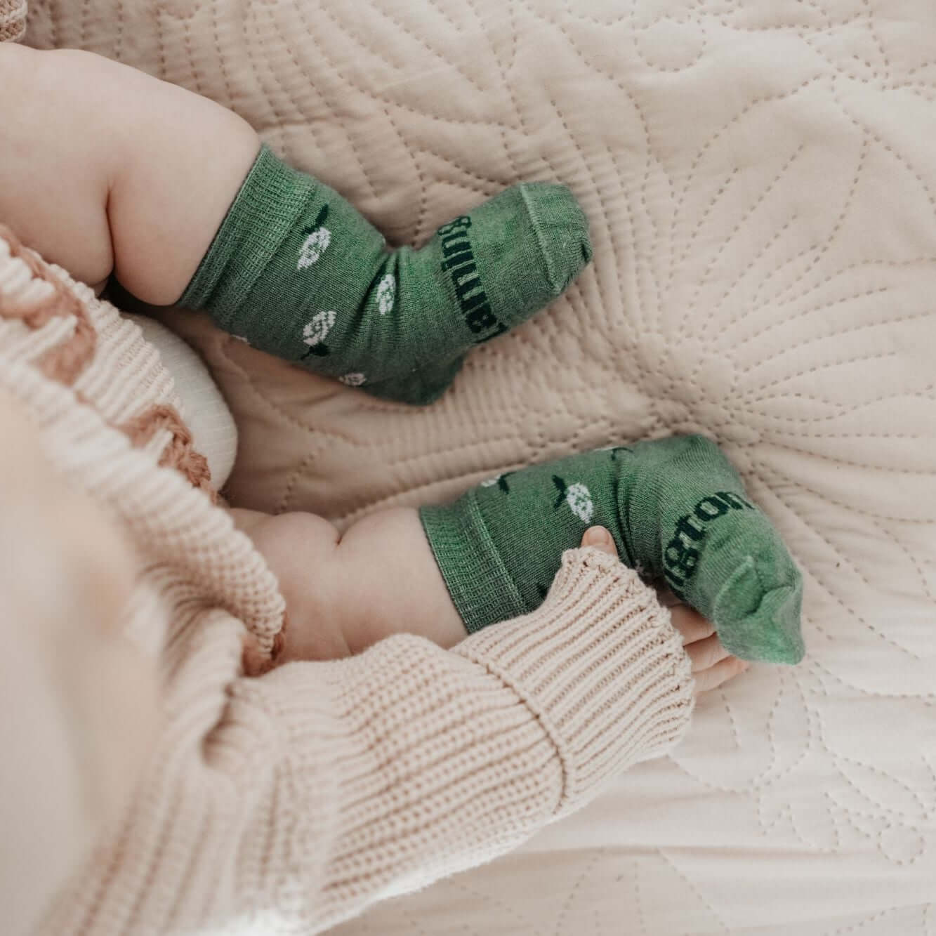 Lamington baby merino crew socks in sage green with natural floral pattern made in New Zealand.