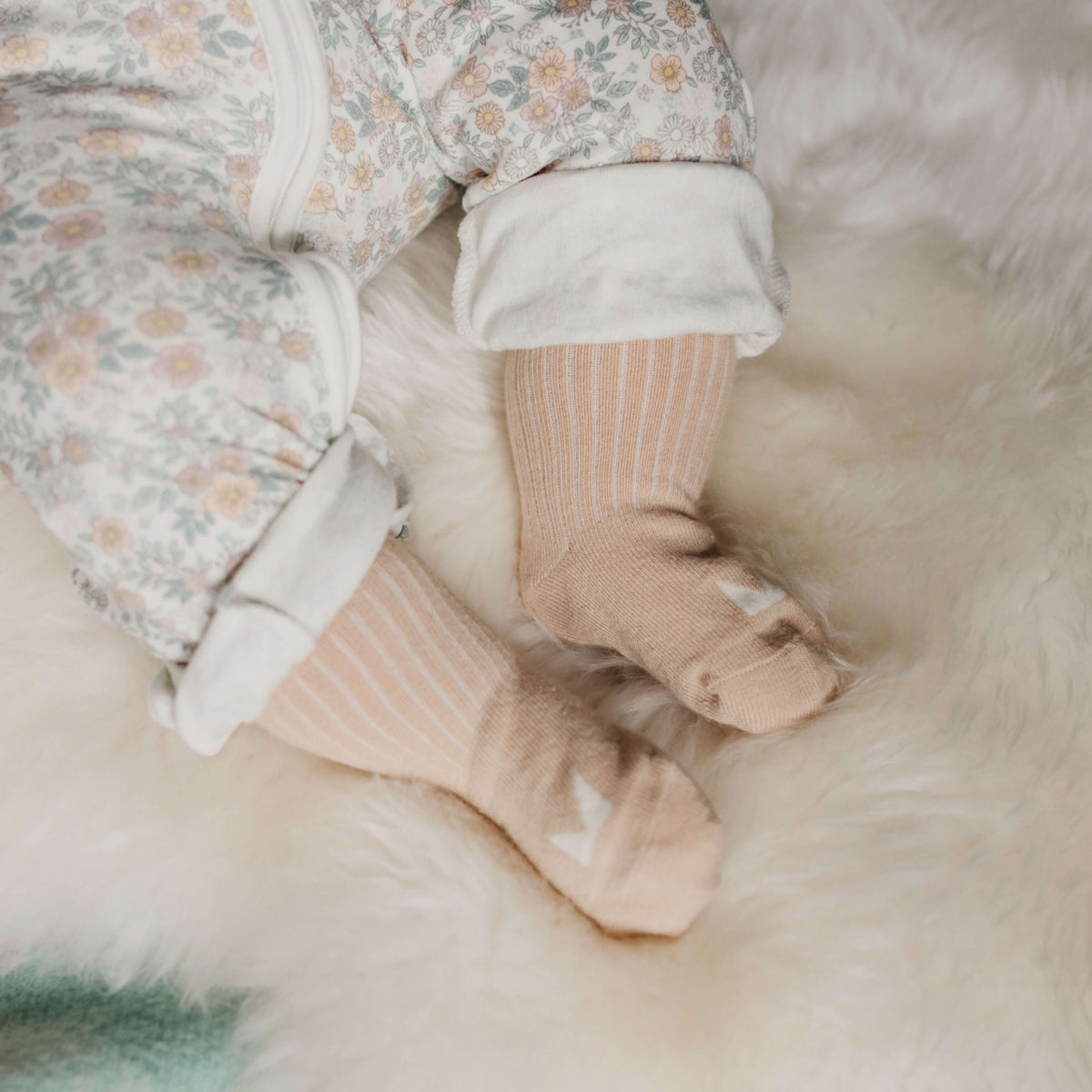 Baby wearing Mosey by Lamington organic cotton baby socks in oatmeal.