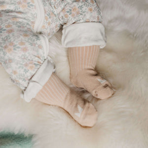 Baby wearing Mosey by Lamington organic cotton baby socks in oatmeal.