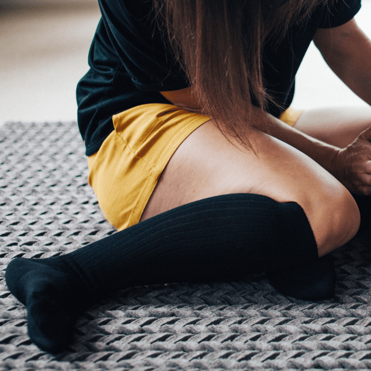 woman wearing black knee-high merino wool socks aus